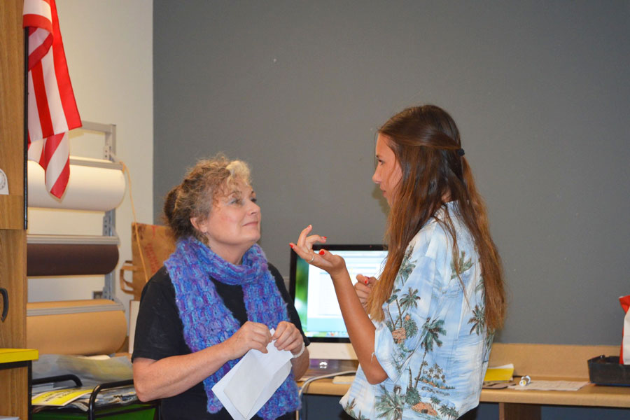 STUDENTS TAKING ART TO THE NATION: Stan club advisor, Jan Colt is consulted by Shelby Myers regarding ideas about upcoming Holiday Gram sales. Jan Colt plans to hold similar fundraisers throughout the year in an effort to raise money for future art courses. 