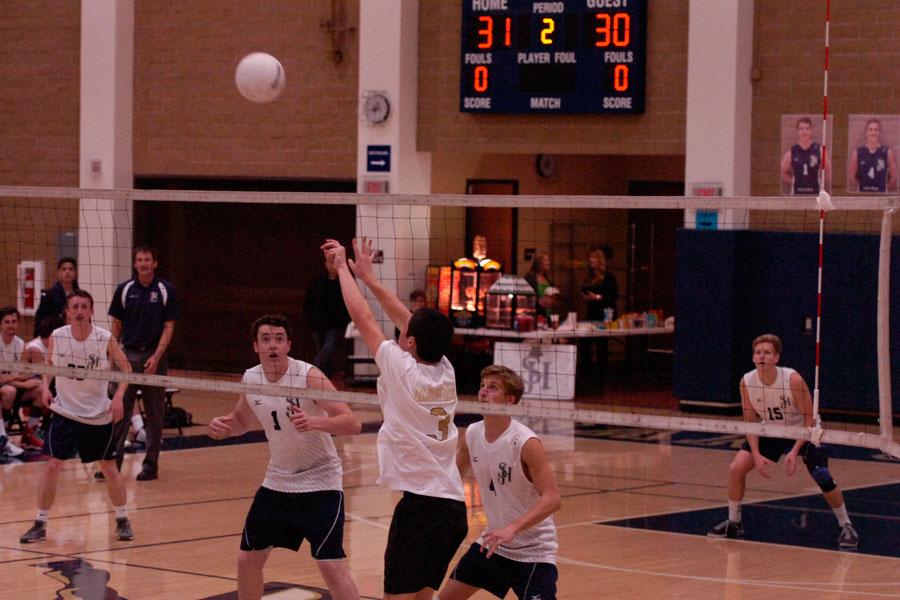 Luke Biggs (12) and Jack Gillen (12) anticipate the oncoming ball in their game against Laguna Hills. The scores were 32-30, 26-24, and 25-20. Photo by Chetana Piravi
