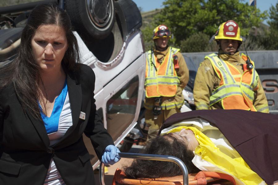 An on-site EMT rolls away the body Esther Ocampo after she was announced dead.