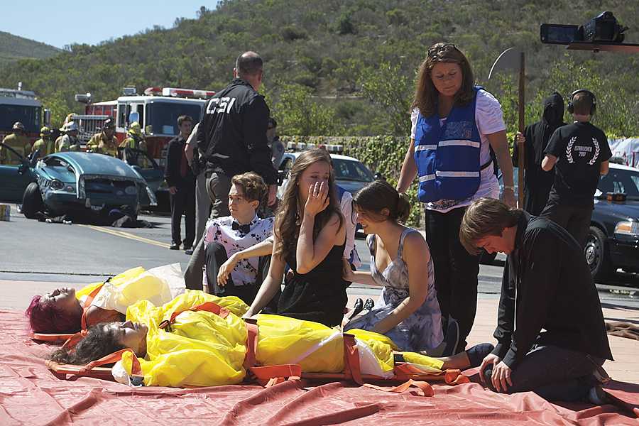 (From left to right): Cole Henriksen (11), Alexis MacAdam (11), Brooke Morris (11), and Connor Hill (11) hover over the bodies of their friends and classmates Samantha Fajardo (12), Esther Ocampo (12) who were killed on scene.