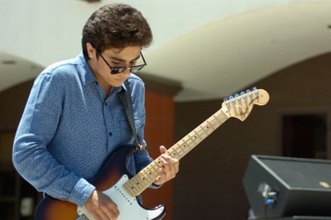GUITAR HERO: Bret Williams performs the guitar in front of the school in the quad.