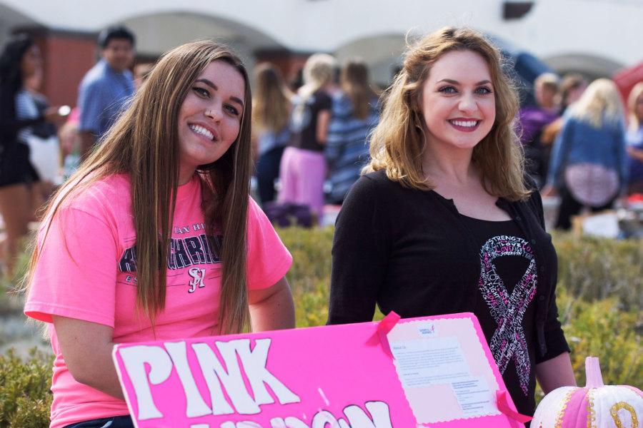 GET YOUR PINK ON: Pink Ribbon Club President, Madeline Blomdahl (12), and Vice President, Danielle Didier (12), set up their booth for Club Rush in which they gained over 100 new club members. The club hopes to influence the student body to become involved in the fight against breast cancer. The next Pink Ribbon Club meeting is on Nov. 21 in Mr. Lynde’s classroom (H104).

