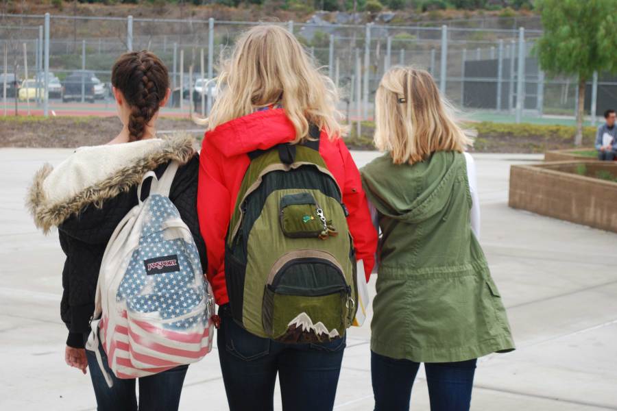 ALL BUNDLED UP: From left to right: Rachel Betts (11), Raymie Bucknam (11), and Izzy Ruedisueli (11), walk to Spanish Club in their winter wear. It is unusual to see people dressed in this attire in southern California. 