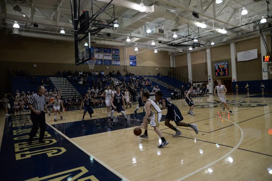 Blake Markovich (12) aggressively  drives to the basket for 2 points in a 78-72 win against Laguna Hills. The stallions are 3-3 in league play and play tonight against Tesoro. 
