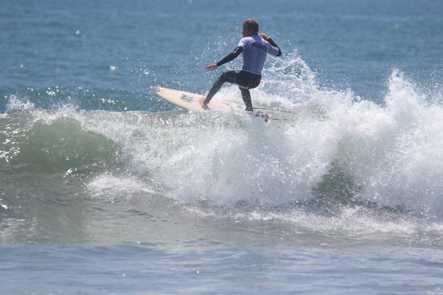 Kolton Sullivan (12) rides a gnarly wave during the 2016 Scholastic Surf Series Section B Competition.  Kolton helped the team win the Mens Longboard Championship for the 6th year in a row, and contributed to SJHHSs overall Championship victory.  