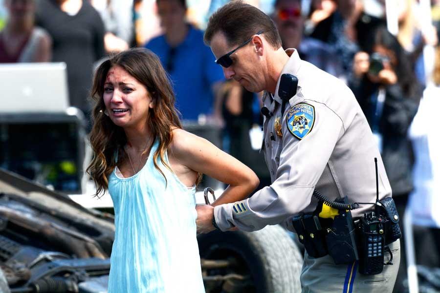 Devyn Madrid (12), who portrayed the drunk driver, cries as she is getting arrested for driving her friends to prom after having a few drinks.

