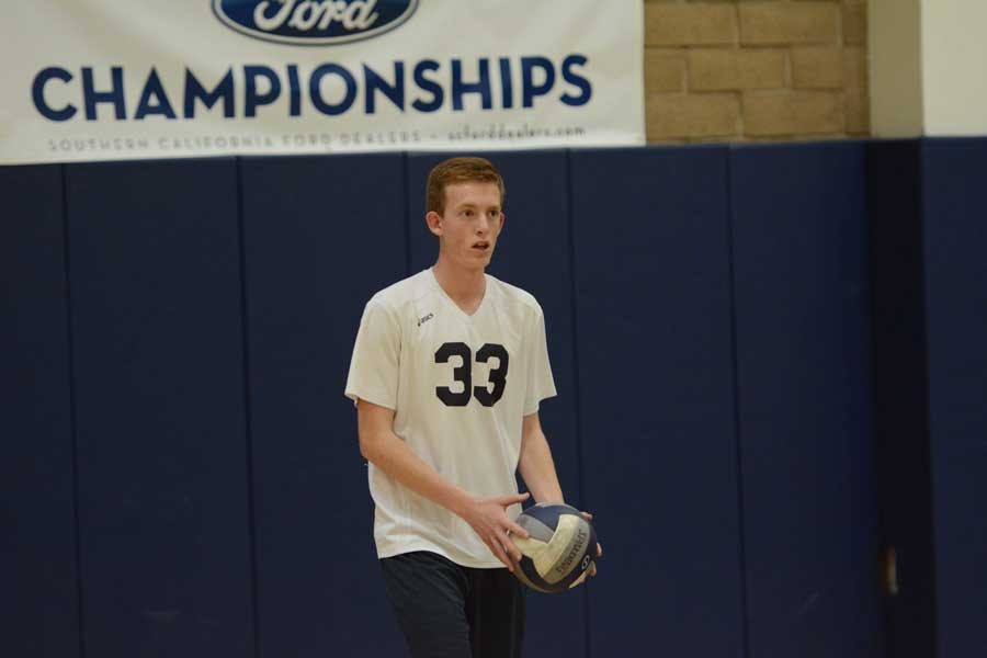 Ben Edwards (10), who plays center and middle on the court, prepares to serve the ball at his Mar. 24 JV volleyball game.  To most people, his half-blindness goes unnoticed, and many cannot truly realize how much concentration it takes to play sports with only one functioning eye.