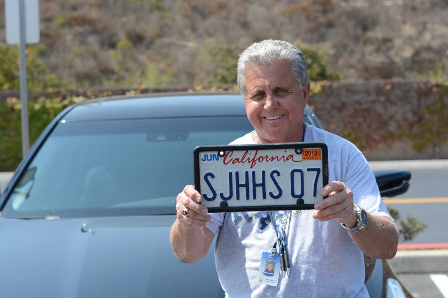 Frank Milano, one the longest working supervisors on this campus, showing off his SJHHS 07 custom license plate that represents when he started working here and when the school opened.