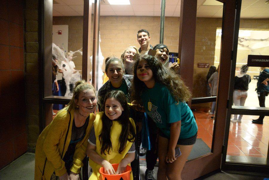 Senior Link Crew Leaders (from Left to Right), Sarah Yeager, Samantha Eden, Kira Rapp, Serenity Church, Liam Childs, Niayla Miller, and Mia Jones greet Freshmen into Linktoberfest with candy, hotdogs, smiles, and halloween spirit.  The leaders played The Nightmare Before Christmas as their featured spooky film.