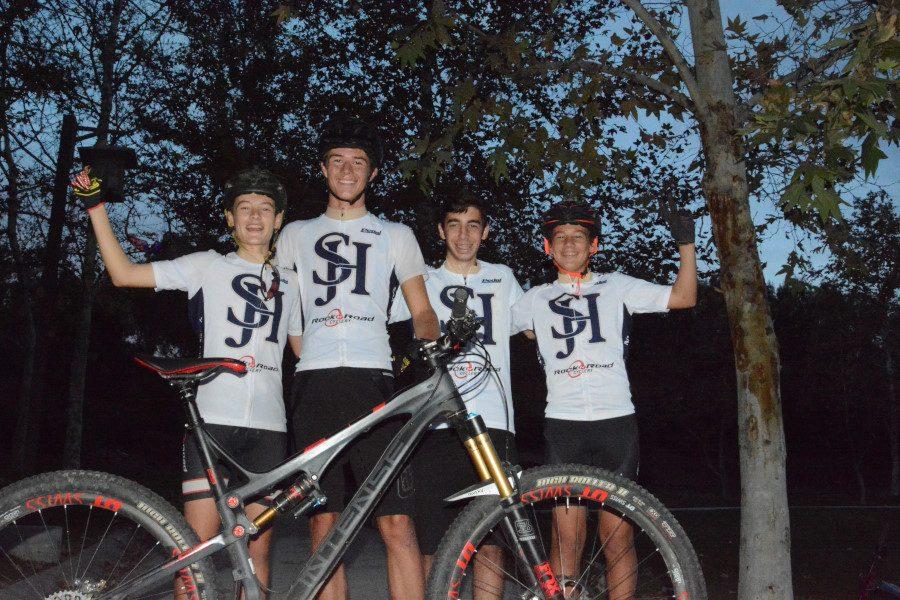 Four members of the Mountain Biking Club pose for a group photo after a night ride.