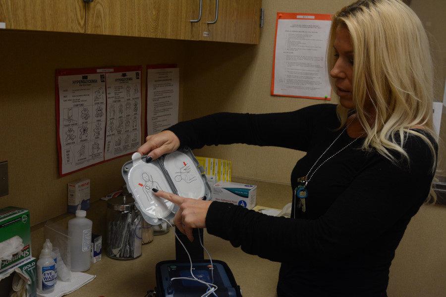 SJHHS’ Licensed Vocational Nurse, Kerry Coryell, demonstrates a diagram on how to operate the portable defibrillator, or AED for short. In the case of a medical emergency, SJHHS’ campus has many AEDs to ensure safety and immediate response to any dilemma.