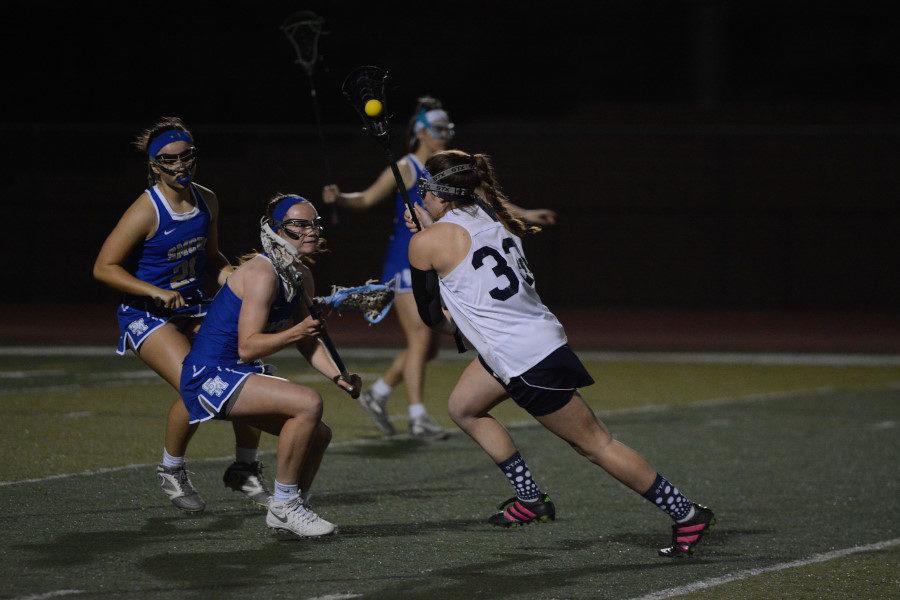 Attackmen, Hannah Miller who recently signed with Division ll Rockhurst University, dodges a Dana Hills defender while going to goal.