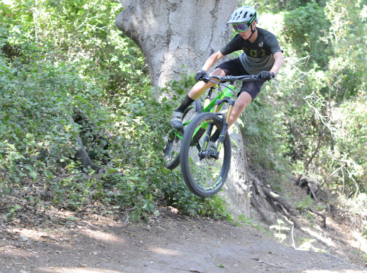 Gavin Fluegge goes off a jump and throws a whip through a bush at Waterworks in Rancho Santa Margarita. He has been biking for two years and now is sponsored by and rides for the Intense race team.