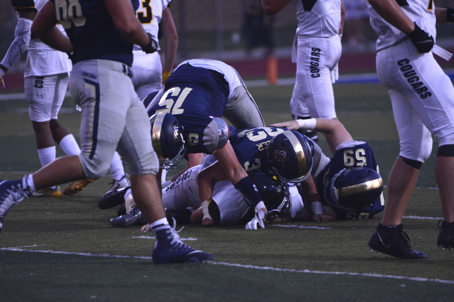 SJHHS+varsity+defense+players+tackle+the+Capo+Valley+running+back+for+another+turnover+on+downs.