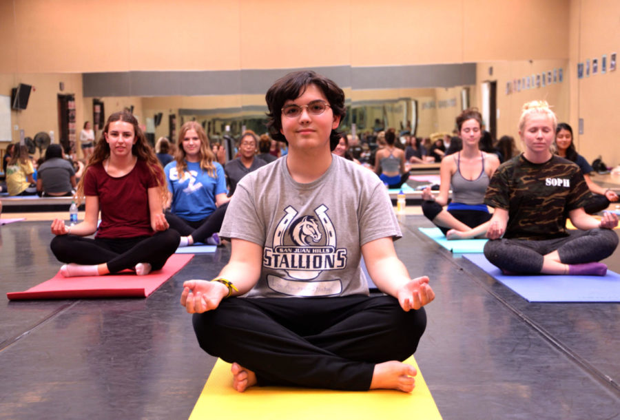 Aguirre-Stanton, along with the rest of the 5th period yoga class, demonstrate the Sukhasana pose, also known as the “Easy Pose.” This, along with other yoga poses the students learn help maintain physical and mental health.