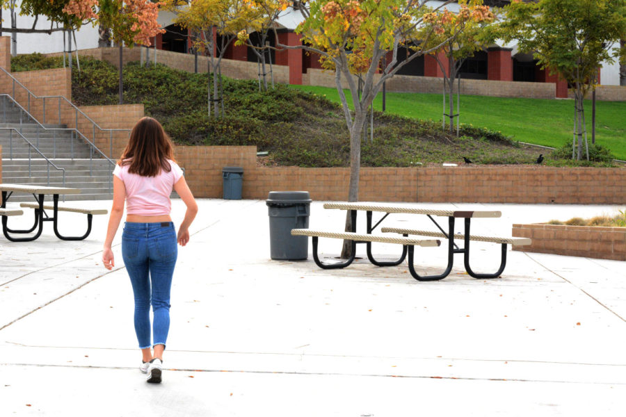 At SJHHS, female students are the main victims of dress code. Here, a female student walks through the lower quad with her mid-drift exposed, which goes against dress code policy at San Juan.