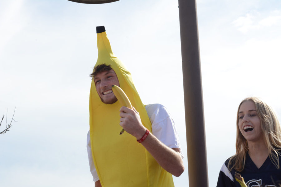 Jeri and Jared Tretter (12) celebrate Banana Day before passing the role onto two juniors. They sat on top of a trash can and ate their bananas at lunch in celebration.