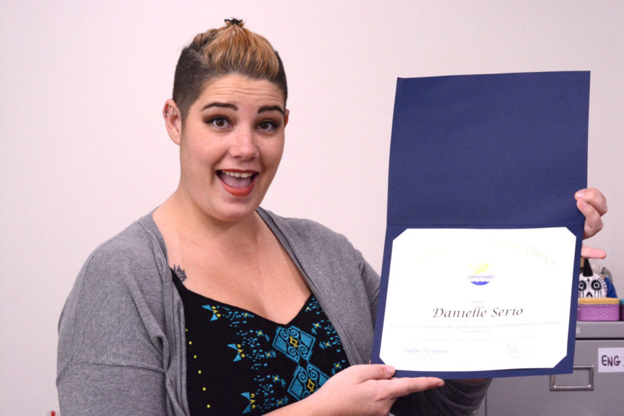 Danielle Serio holding the certificate for the Extra Miler award she won on November 8.
