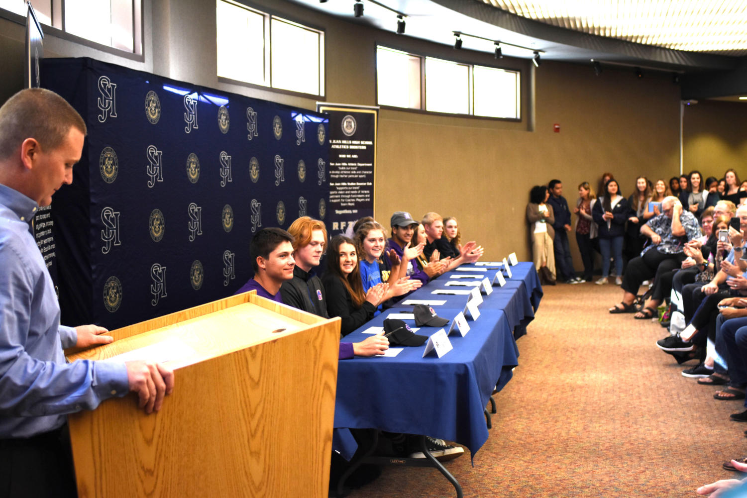 Students at SJHHS sign their letters of intent to colleges that have offered them scholarships to compete in their athletic programs.