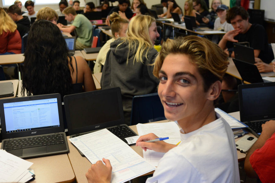 Some eligible SJHHS students register to vote during tutorial on October 2. Keegan Bengelsdorf (10), smiles while filling out his voter pre-registration form