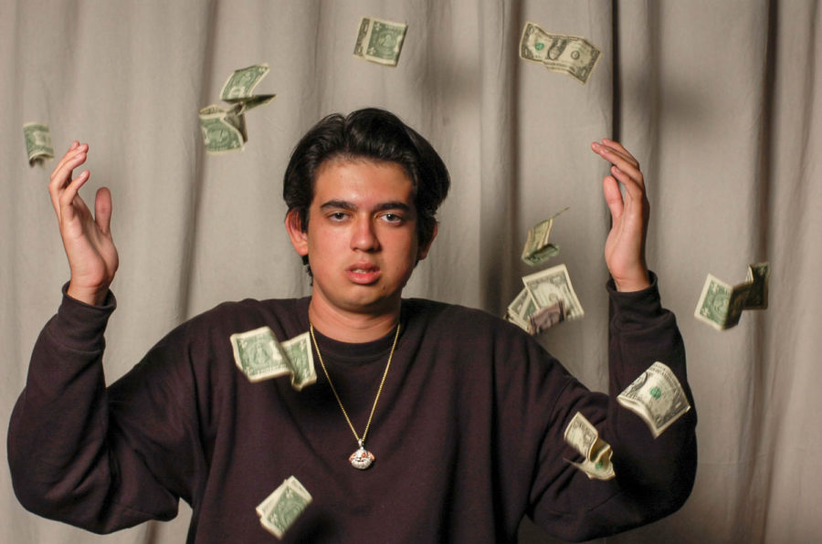 Alec Tighe (12) showers in dollar bills after releasing his first debut album, “Alectober,” on Soundcloud, October 25.