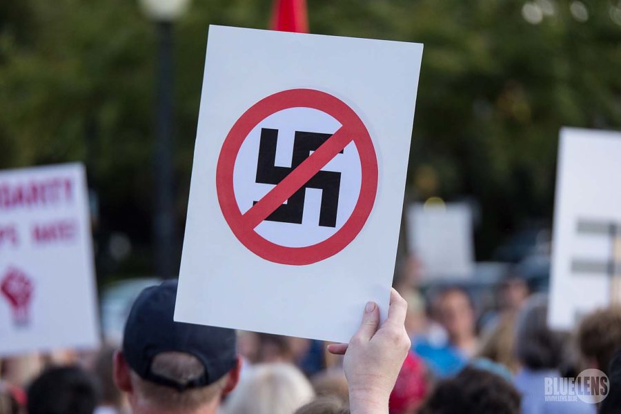 White+supremacists+and+neo-nazis+gather+in+Charlottesville%2C+Virginia%2C+for+the+Unite+the+Right+rally%2C+holding+anti-semitic+posters%2C+while+counter-protesters+hold+their+anti-racism+signs.