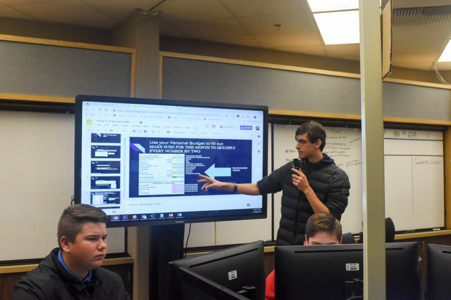 Jimmy Wale (11) conducts a presentation to the virtual enterprise class during second period on Thursday, November 29.