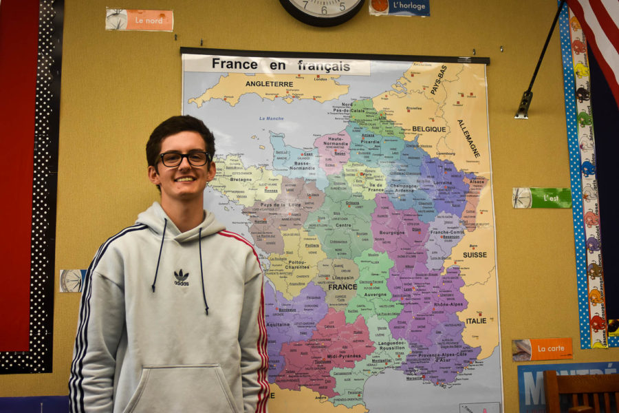 George stands in front of a map of France inside Mrs. Kellers French classroom. His home of Compiegne, France is in the Northern region of the country.