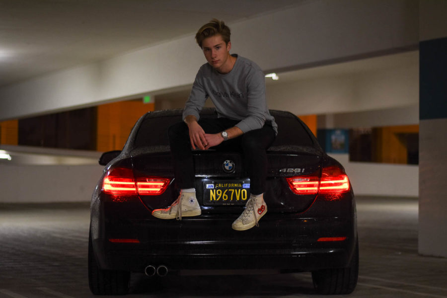 With a Gucci belt, Calvin Klein shirt, and a flashy watch, Elliot MacAdam sits on the trunk of his black BMW 2015 428i coupe. With a 2.0 liter 4 cylinder engine, his BMW makes 240 horsepower and 255 lb-ft of torque. Equipped with launch control, it is able to do 0-60 mph in 5.5 seconds.