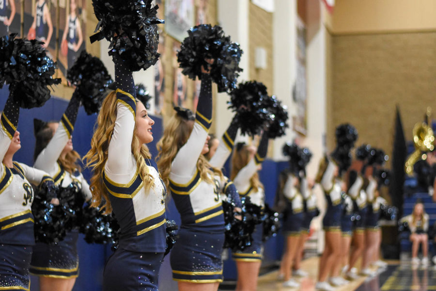 Lady stallions cheer on the boys varsity basketball team as they face off against Tesoro in the home black-out game.