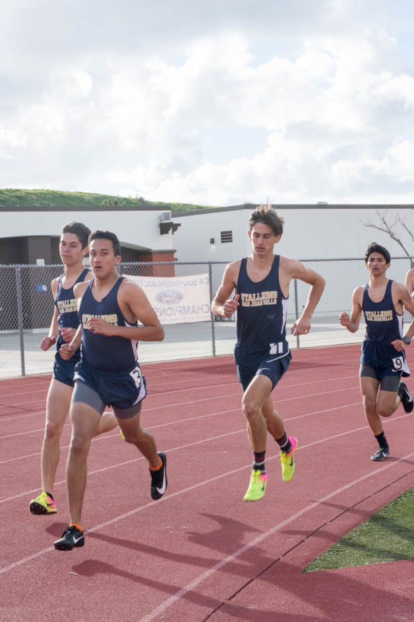 Raymond Rojas (11) leads in the 1600m meter race at the intrasquad track meet on Thursday, February 21, with Josh Dalo (12), Cole Smith (12), and Dalton Flores (12) catching up behind him.