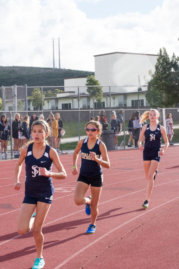 Shirin Dunker (9), Isabella Zuniga (10), and Emili Peo (9), finish in first, second, and third place in the Varsity 1600 meter run at the intrasquad track meet on February 21 in the Badlands.