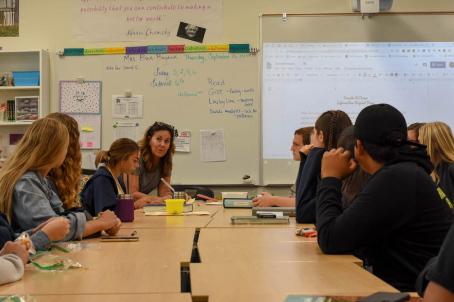 Christine Bak-Boychuk, the club advisor, discusses the allocation of donated money with members of the Donate-A-Dance club.