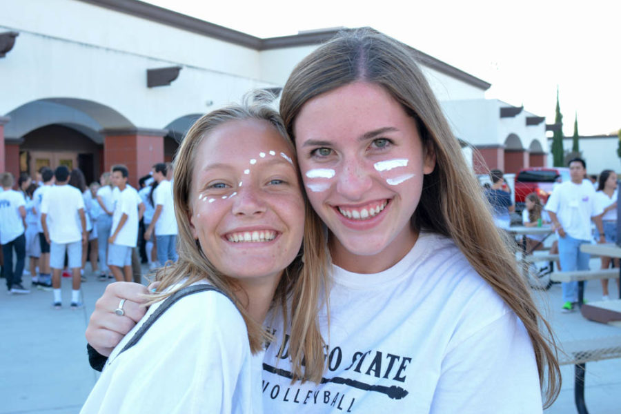 Link Crew leaders Lily Keeler (11) and Savannah Goodpaster (11) help lead the Freshmen Tailgate party before the football game.