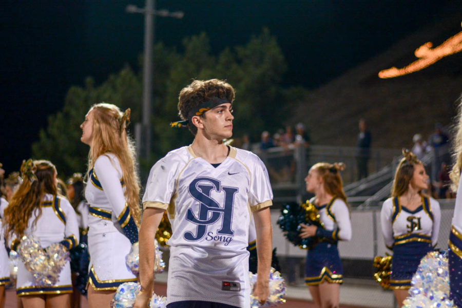 Zach Rothman (12) looks out into the stands while he cheers on the football team on September 6. He dances as well as cheers for the crowd because he is on the song team, which was created this year at SJHHS.