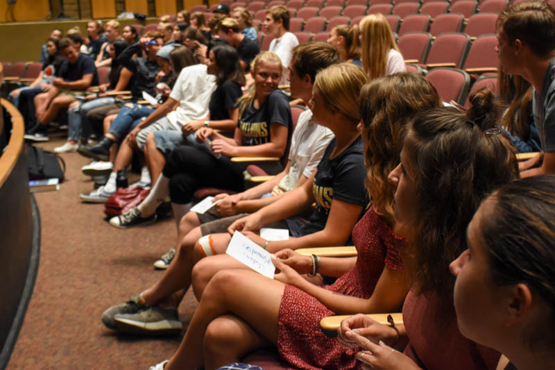 Students who were accepted into National Honors Society sit and listen to instruction during the rehearsal meeting.