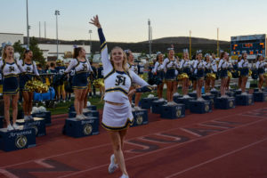 The new song team is introduced at the white out football game in the Badlands. Sarah Hansen (11) hypes up the crowd after she performed.
