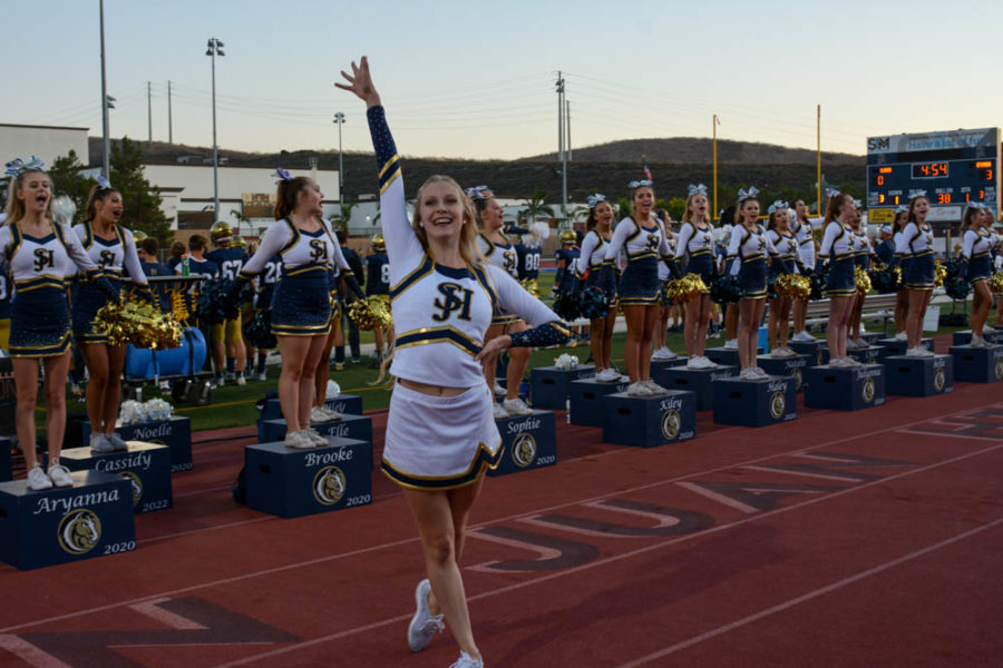 The new song team is introduced at the white out football game in the Badlands. Sarah Hansen (11) hypes up the crowd after she performed.