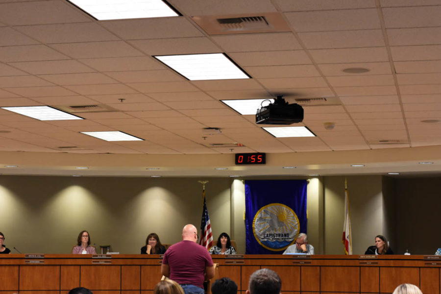 Board members listen to public comment by a concerned parent regarding the racist allegations from SCHS football game.