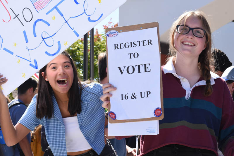  Julia Lehman (10) and Gabby Laurente (10) encourage passersby to fill out voter registration forms. While not apart of a club, Lehman and Laurente volunteered to promote voter registration in order to increase interest and participation among new voters in the upcoming election