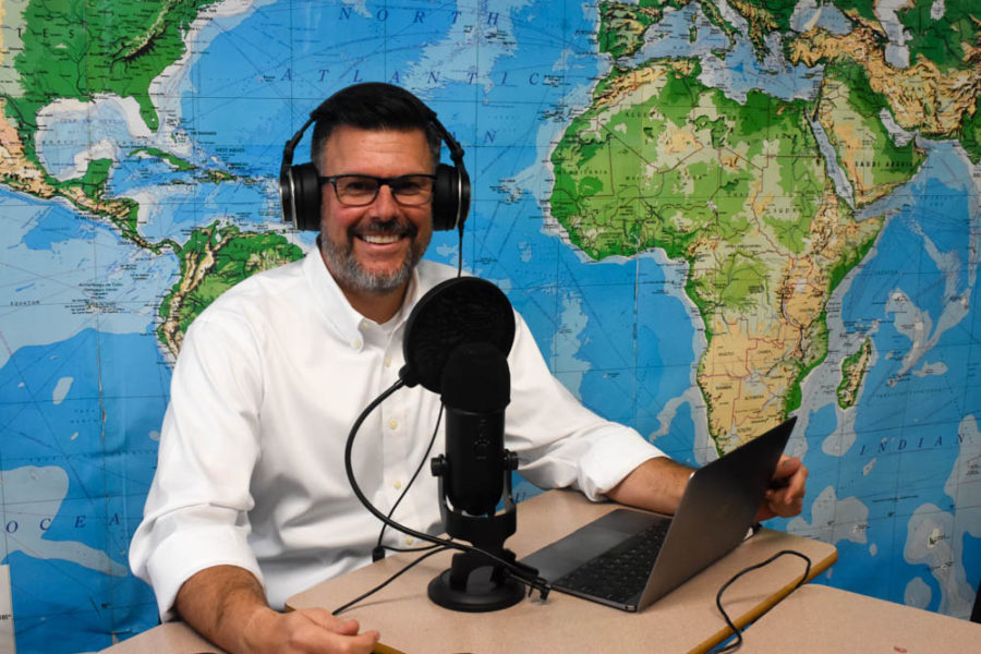 Lynde smiles as he records for his podcast, Lyndeurozone Euro Simplified. His podcast has helped hundreds of his students successfully pass their AP European History exams.