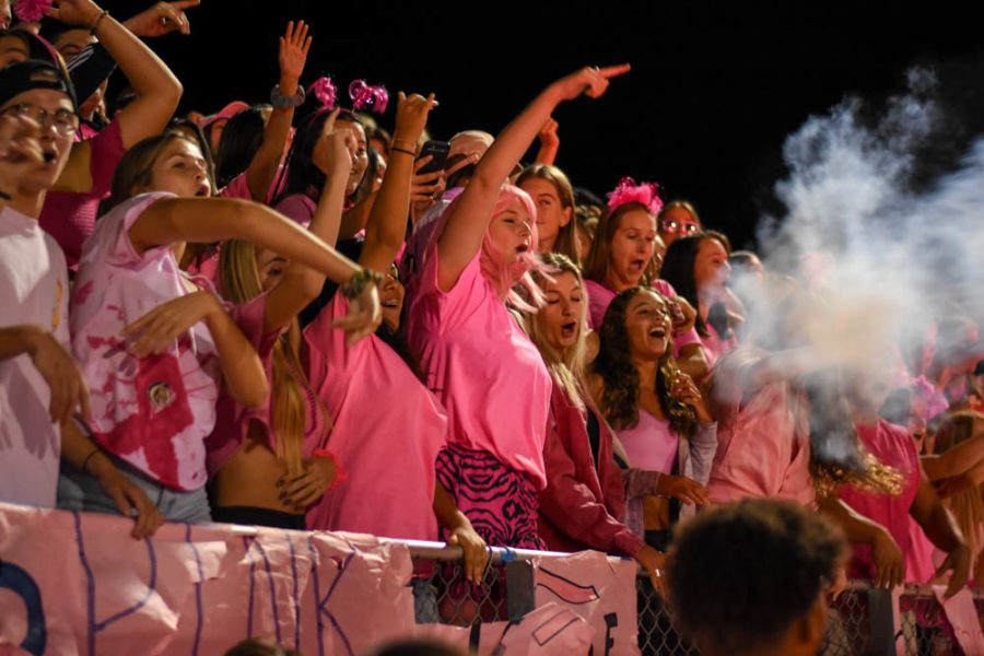 Students celebrate and sing in the senior section after the Stallions score another touchdown. The team scored 57 points in total compared to the Dolphins’ score of 14 by the end of the game.