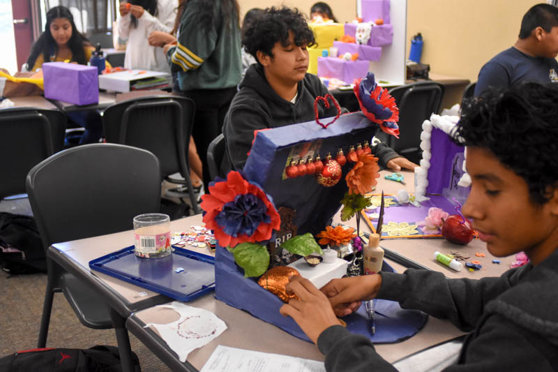 Students in Lorena Sanchez’s Spanish for Spanish Speakers I class work on constructing their altars. The project serves to immerse the students in the Day of the Dead culture and also to connect with loved ones who have passed away through research of their lives.