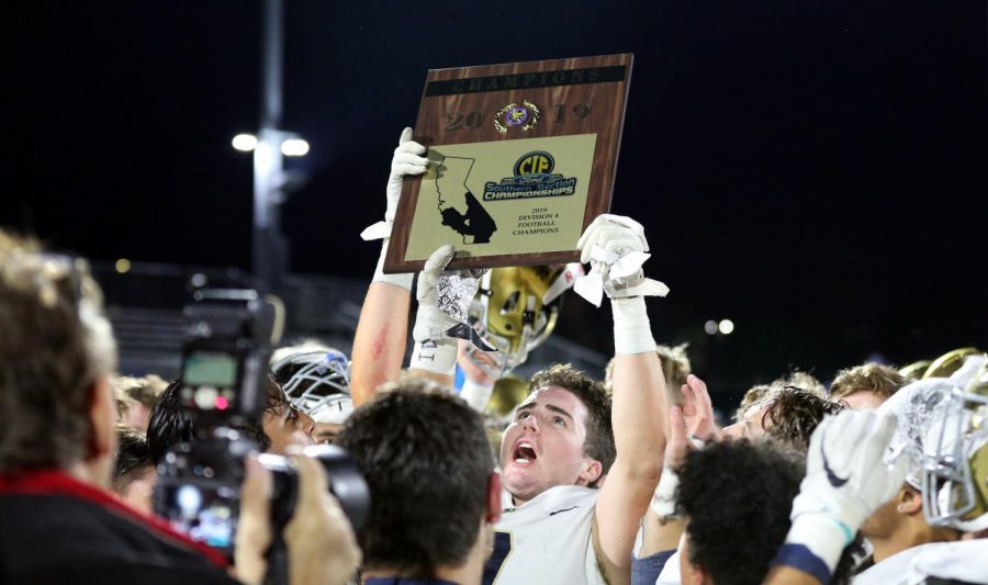Jonah Johnson (12) raises the CIF Championship Plaque in celebration with his teammates and coaches. The Stallion Football team took home the title on November 29 in a game against Loyola High School. They won the game 21-15, earning the schools first ever CIF championship in football.