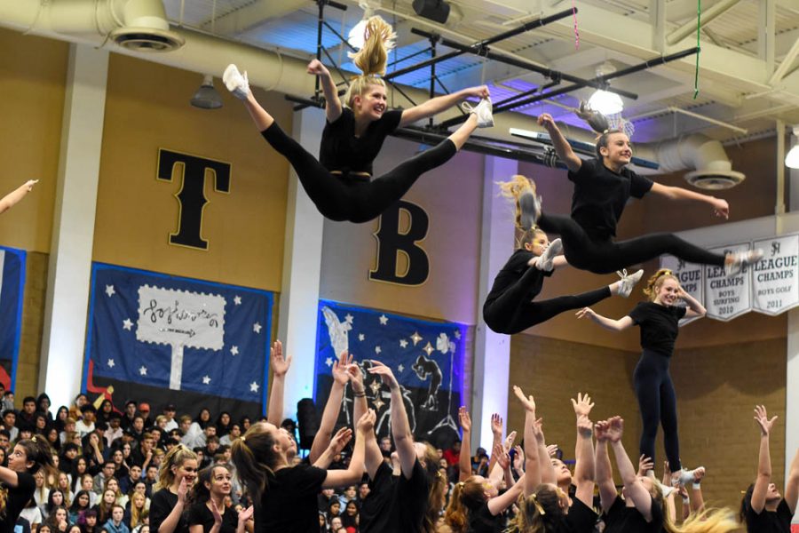  Brooke Scanlon (11) and Marlena Meltzer (10) fly through the air at the Winter Formal pep rally. Pep squad riles up the crowd in preparation for the Grammy’s dance on February 1st.