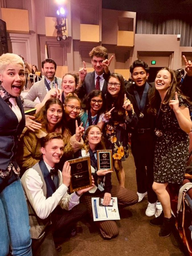 The SJHHS Academic Decathlon team stands on the stage at the Orange County Academic Decathlon Awards Ceremony for winning First Place in their division during the Overall Team Awards section of the ceremony. In addition to this, the team also won 25 individual medals and fourth place in their division for Super Quiz. 