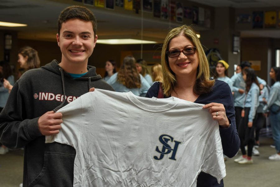While an incoming stallion and his Mom wait in the library for a Link Crew Tour, they pose with a Stallion t-shirt. In the library, stallions were able to purchase shirts, as well as meet with a link crew leader for a tour.