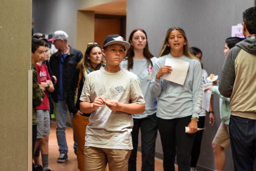  An incoming freshman tours the F building with Link Crew leaders Lucy Hughitt (11) and Jade Hernandez (11). Visual and performing art classes set up booths in the halls to promote their programs in hopes of expanding student interest.