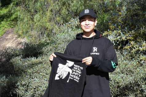 Jeffrey Tobar (12) stands with the Unity Week t-shirts. The design was made by him and other DIRHA members, and will be worn on Monday by students and faculty involved in ASB, Kindness Club, BRIDGES, and DIRHA.