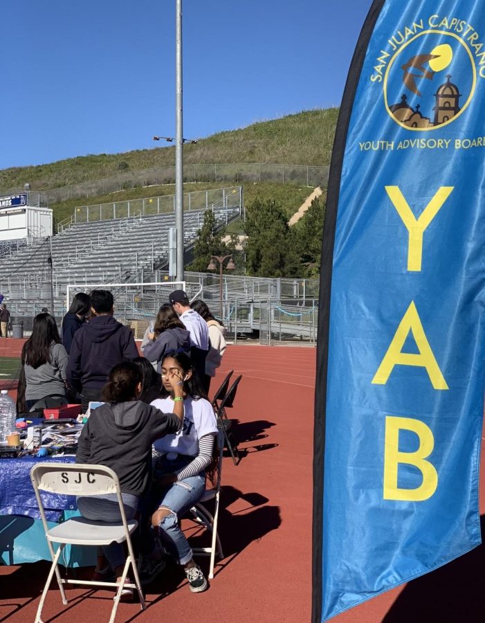 The Youth Advisory Board members paint faces at the SJHHS club Project SOSs Walk for Wellness in February 2019. The Youth Advisory Board often helps run events in San Juan Capistrano by providing services like face painting. 